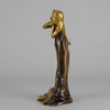 Jeune Femme by C Peyre A very fine Art Nouveau bronze study of a young beauty in coy pose, clothed in a long flowing skirt, her head and arms in gilt bronze to contrast with the rich brown colour of her clothes