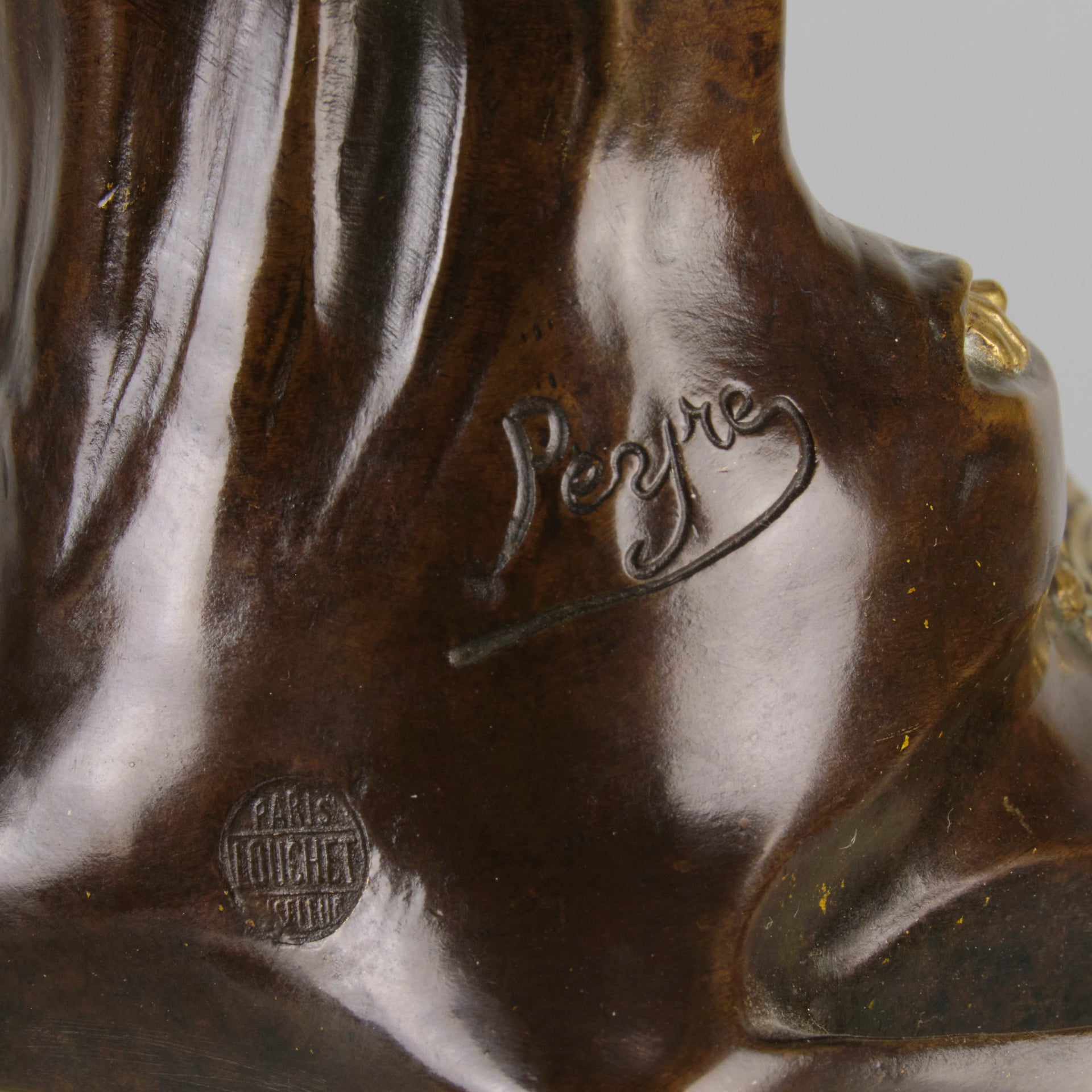 Jeune Femme by C Peyre A very fine Art Nouveau bronze study of a young beauty in coy pose, clothed in a long flowing skirt, her head and arms in gilt bronze to contrast with the rich brown colour of her clothes