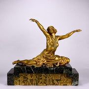 An antique bronze figure Theban Dancer by CJ R Colinet gilt and enamel bronze figure of a seated dancer wearing an exotic and revealing costume, with very fine gilt and enamel colour and excellent detail,