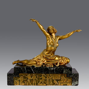 An antique bronze figure Theban Dancer by CJ R Colinet gilt and enamel bronze figure of a seated dancer wearing an exotic and revealing costume, with very fine gilt and enamel colour and excellent detail,