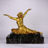 An antique bronze figure Theban Dancer by CJ R Colinet gilt and enamel bronze figure of a seated dancer wearing an exotic and revealing costume, with very fine gilt and enamel colour and excellent detail,