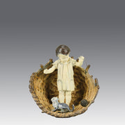 Girl & Cat with Basket - Bergman Bronze - A charming early 20th Century Austrian bronze group study of a young child and cat standing in a wicker basket playing with a ball of string - Hickmet Fine Arts