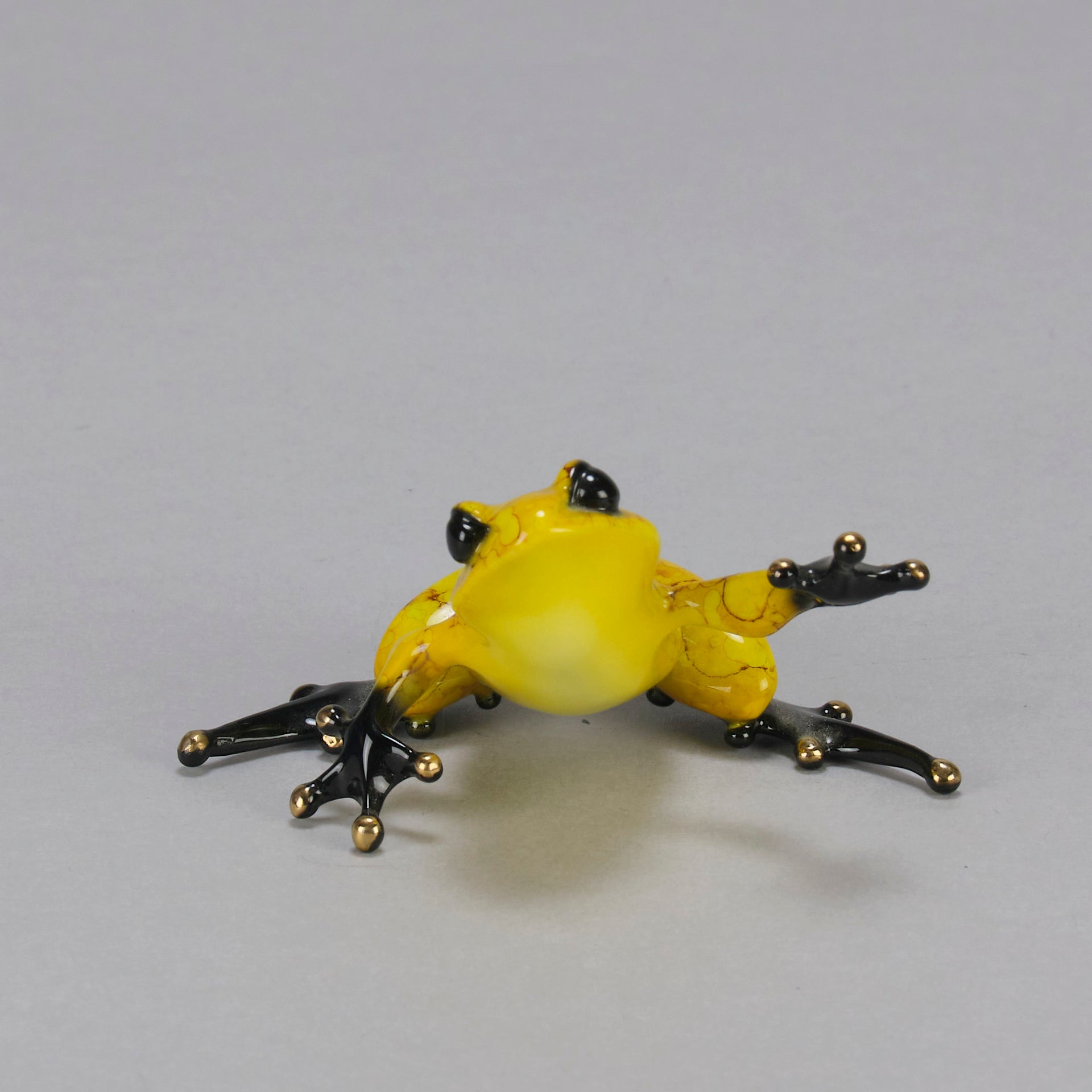 Chai - A vibrant limited edition bronze sculpture by Tim Cotterill of a yellow frog with its head raised, reaching out with its front leg, exhibiting very fine bright enamel colours and excellent tactile surface