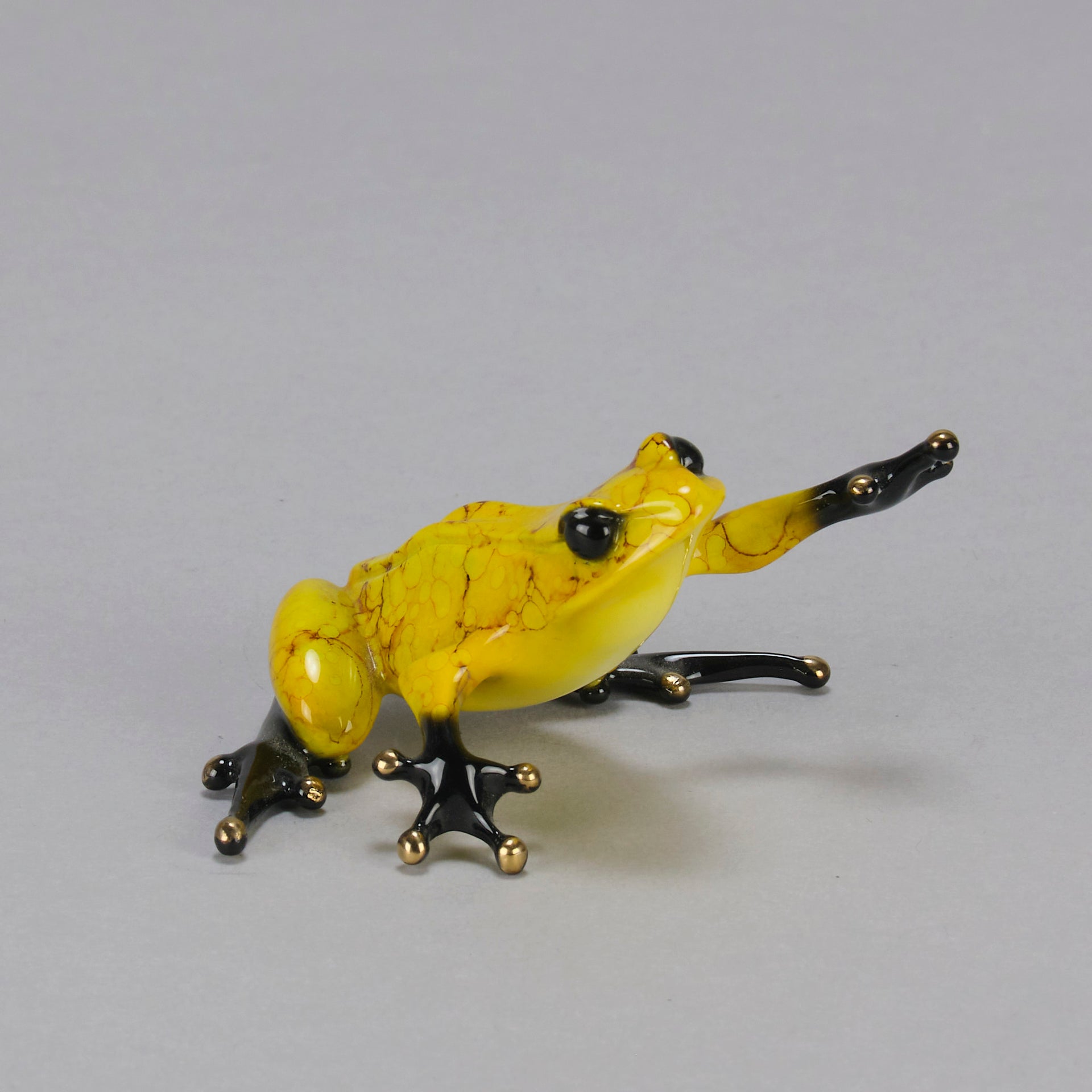 Chai - A vibrant limited edition bronze sculpture by Tim Cotterill of a yellow frog with its head raised, reaching out with its front leg, exhibiting very fine bright enamel colours and excellent tactile surface