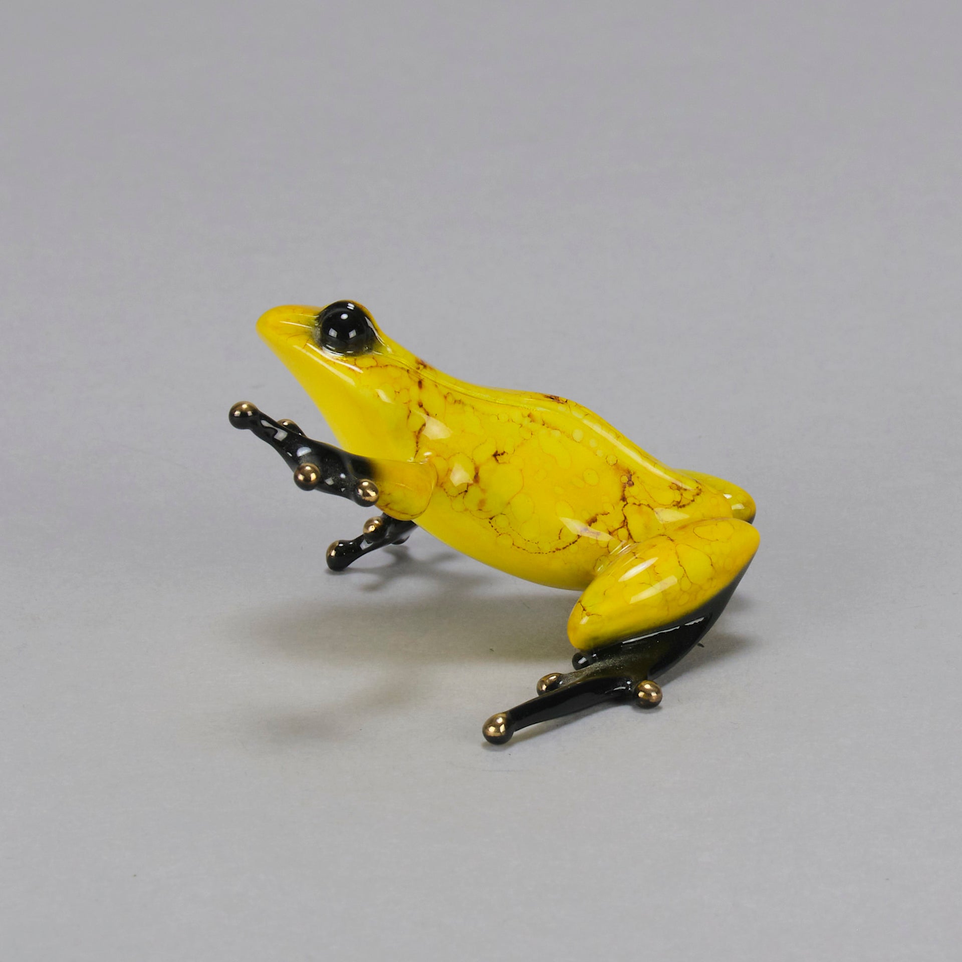 Chai - A vibrant limited edition bronze sculpture by Tim Cotterill of a yellow frog with its head raised, reaching out with its front leg, exhibiting very fine bright enamel colours and excellent tactile surface
