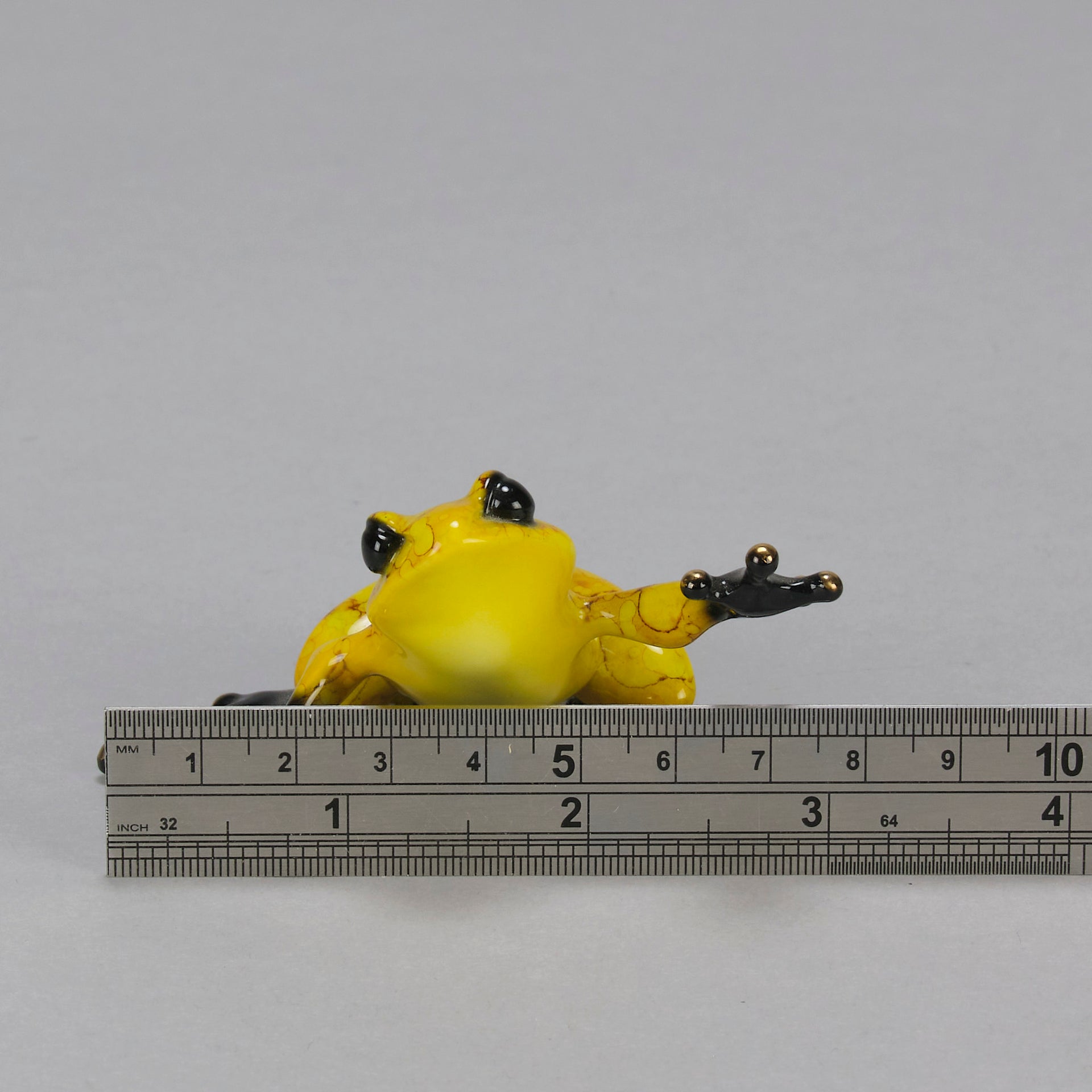 Chai - A vibrant limited edition bronze sculpture by Tim Cotterill of a yellow frog with its head raised, reaching out with its front leg, exhibiting very fine bright enamel colours and excellent tactile surface