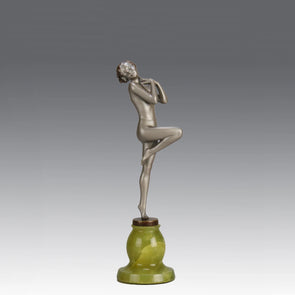 Art Deco Sculpture - Deco Dancer  by Josef Lorenzl  a cold painted bronze figure of a young woman holding a dancing pose with her hands lifted across her chest. The bronze figure with excellent colour and very fine hand chased surface detail, raised on a green onyx base  