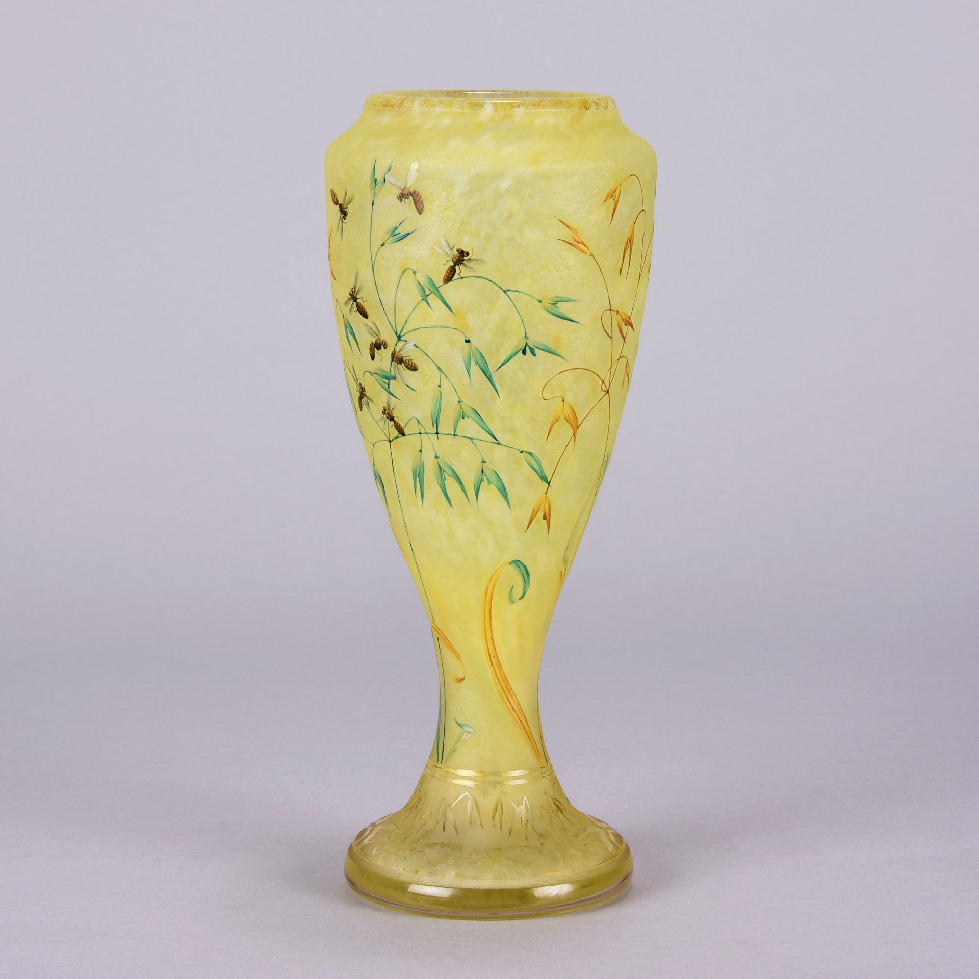 Bees and Flowers Vase by Daum Frères a late 19th Century French cameo glass vase etched and enamelled with a hive of bees pollinating flowers against a pale yellow field