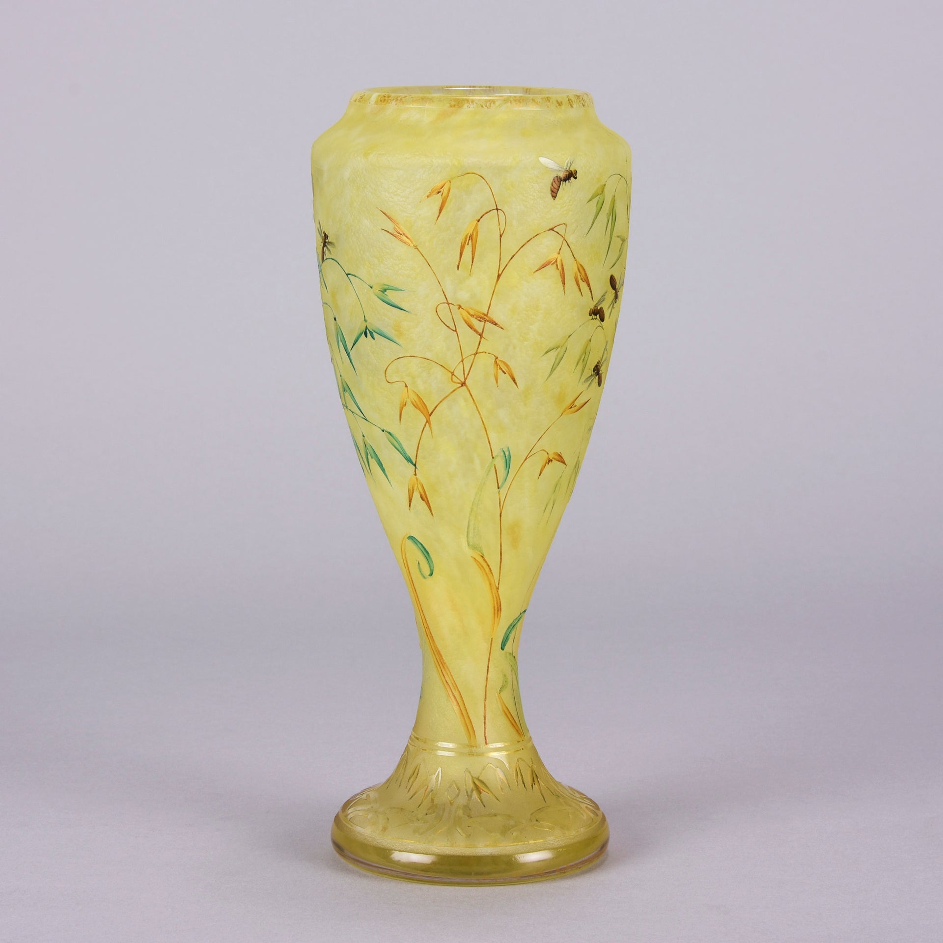 Bees and Flowers Vase by Daum Frères a late 19th Century French cameo glass vase etched and enamelled with a hive of bees pollinating flowers against a pale yellow field