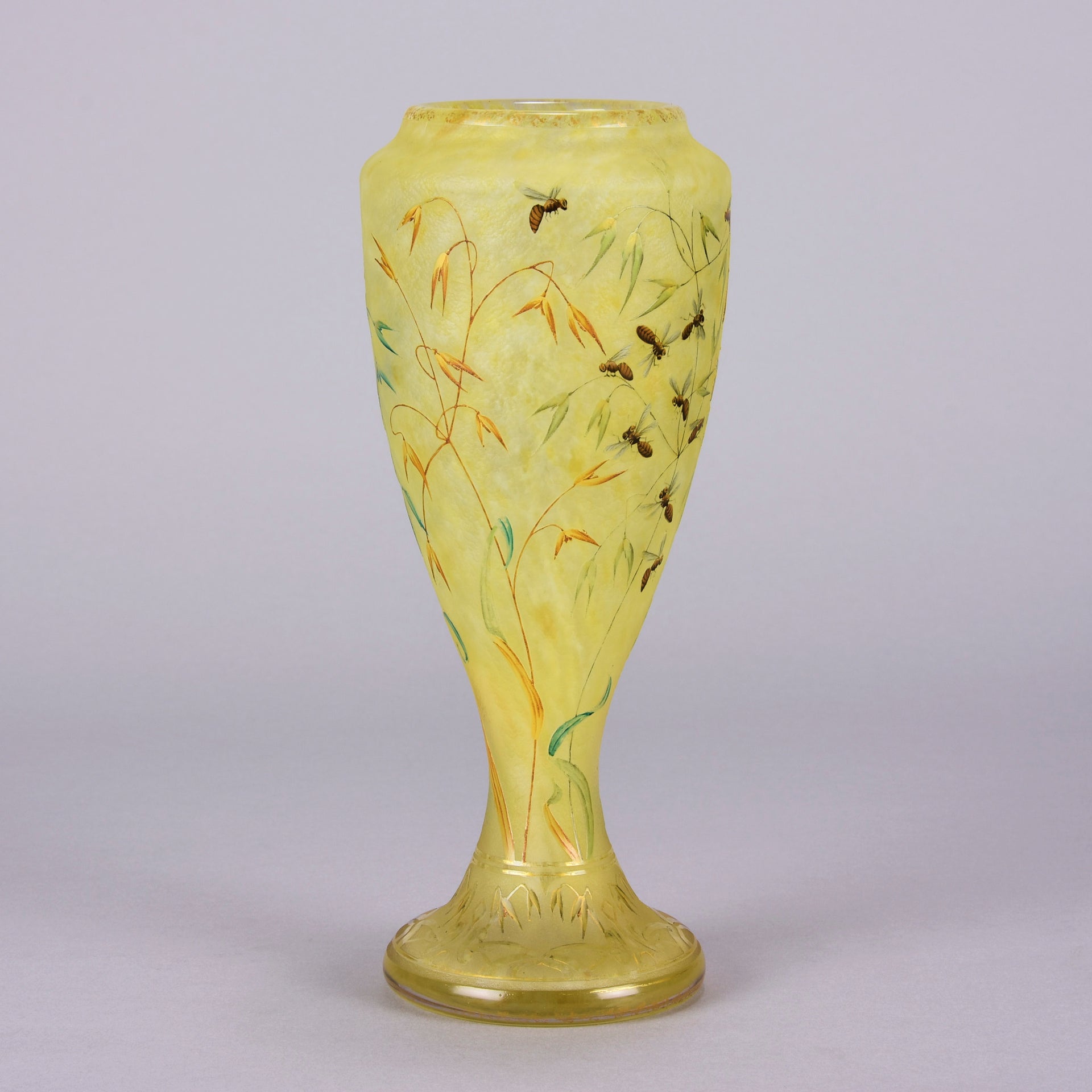 Bees and Flowers Vase by Daum Frères a late 19th Century French cameo glass vase etched and enamelled with a hive of bees pollinating flowers against a pale yellow field