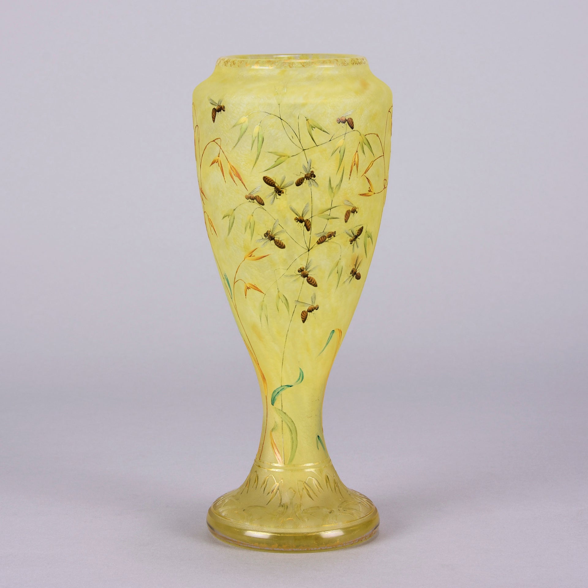 Bees and Flowers Vase by Daum Frères a late 19th Century French cameo glass vase etched and enamelled with a hive of bees pollinating flowers against a pale yellow field