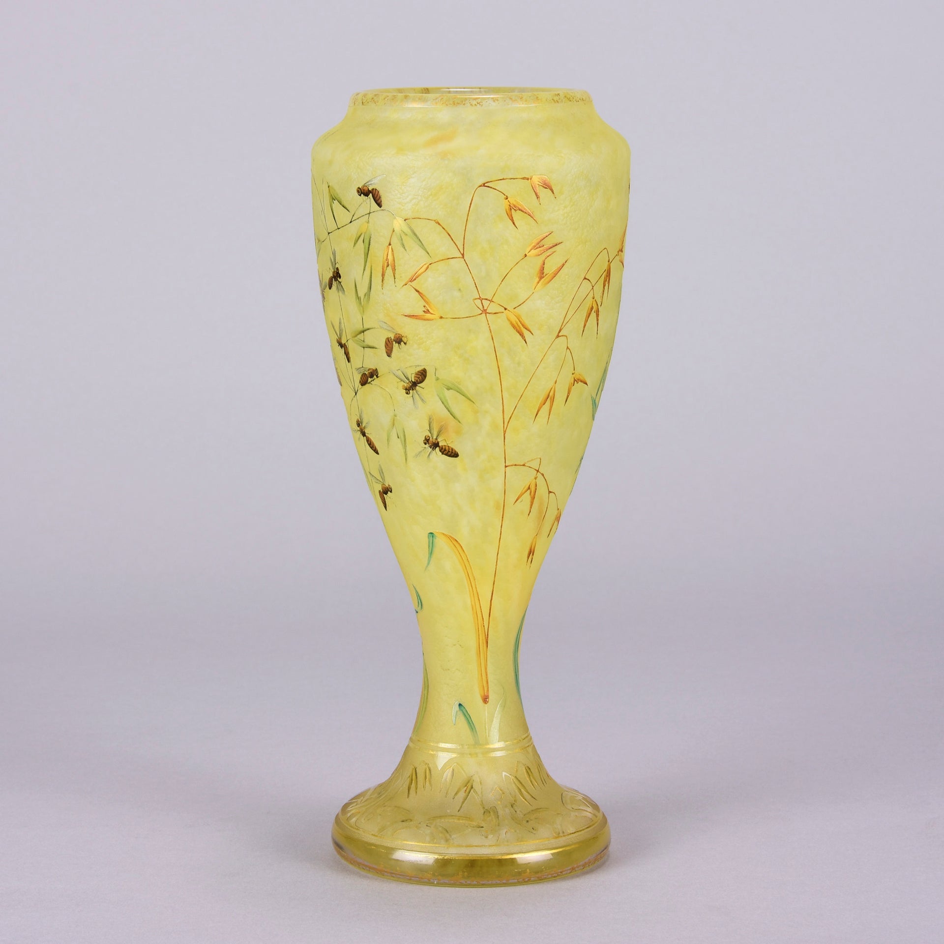 Bees and Flowers Vase by Daum Frères a late 19th Century French cameo glass vase etched and enamelled with a hive of bees pollinating flowers against a pale yellow field