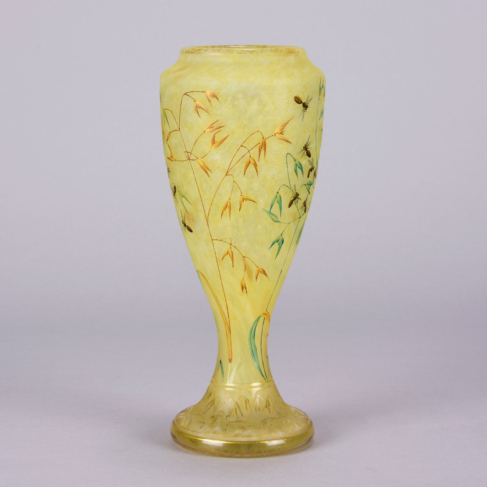 Bees and Flowers Vase by Daum Frères a late 19th Century French cameo glass vase etched and enamelled with a hive of bees pollinating flowers against a pale yellow field