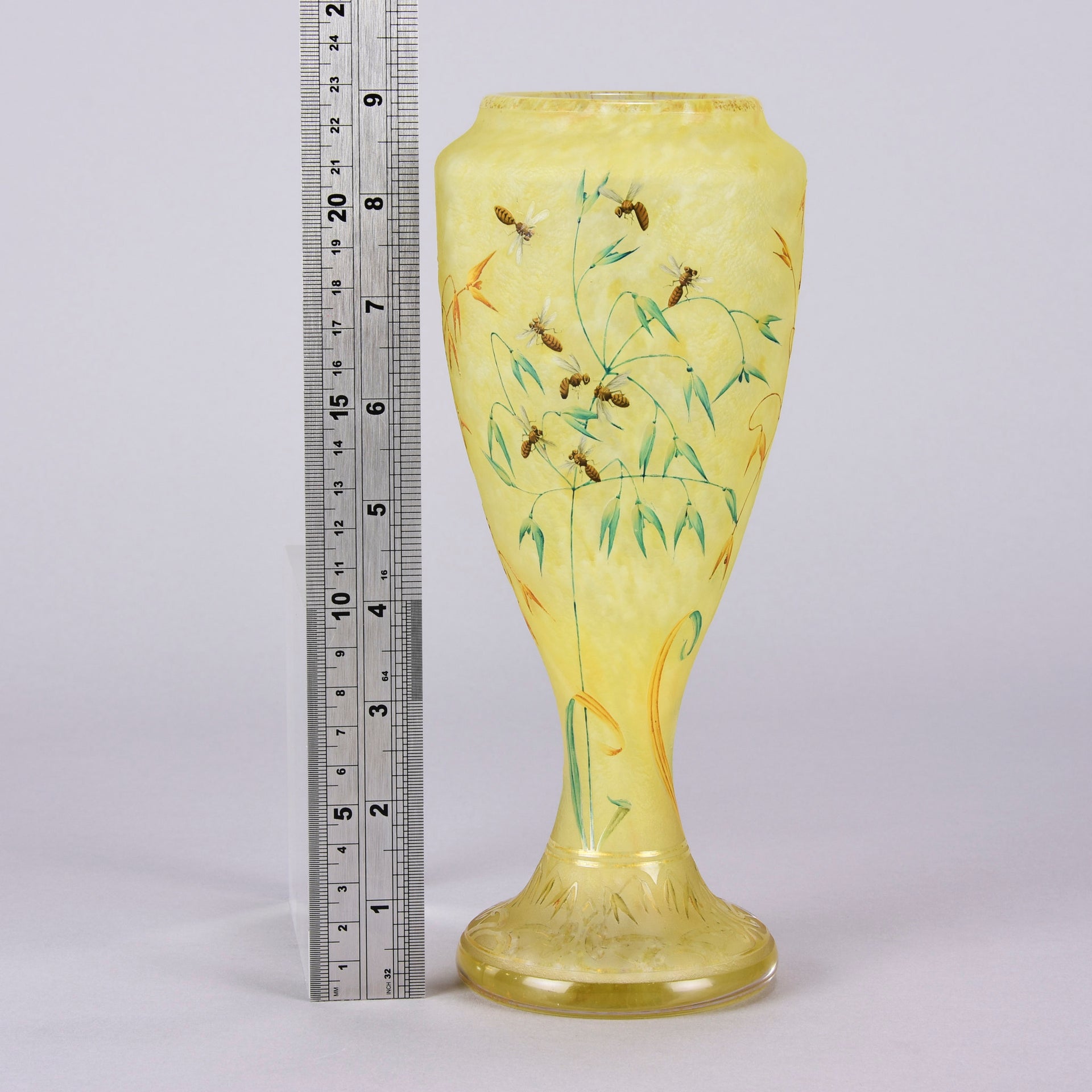 Bees and Flowers Vase by Daum Frères a late 19th Century French cameo glass vase etched and enamelled with a hive of bees pollinating flowers against a pale yellow field