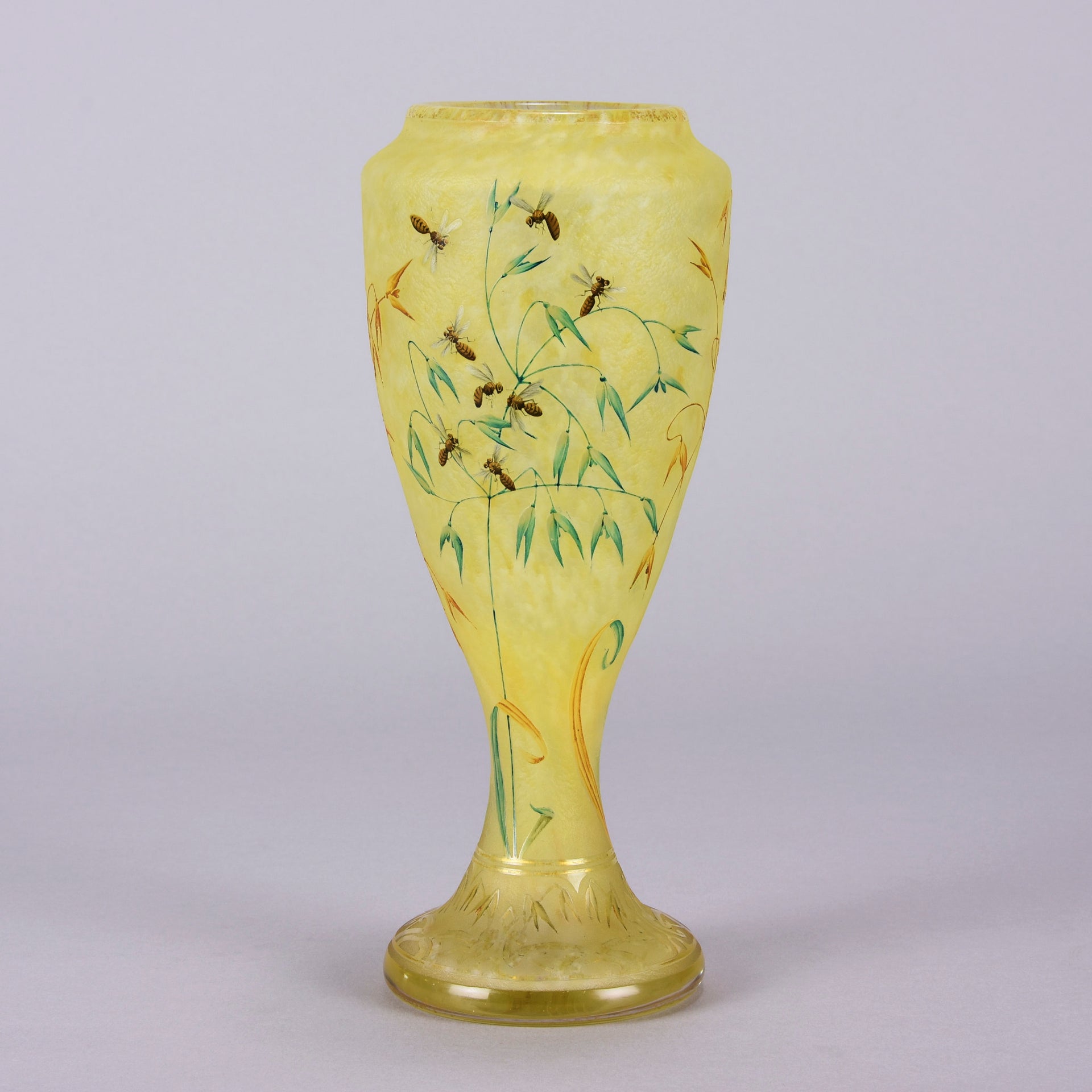 Bees and Flowers Vase by Daum Frères a late 19th Century French cameo glass vase etched and enamelled with a hive of bees pollinating flowers against a pale yellow field