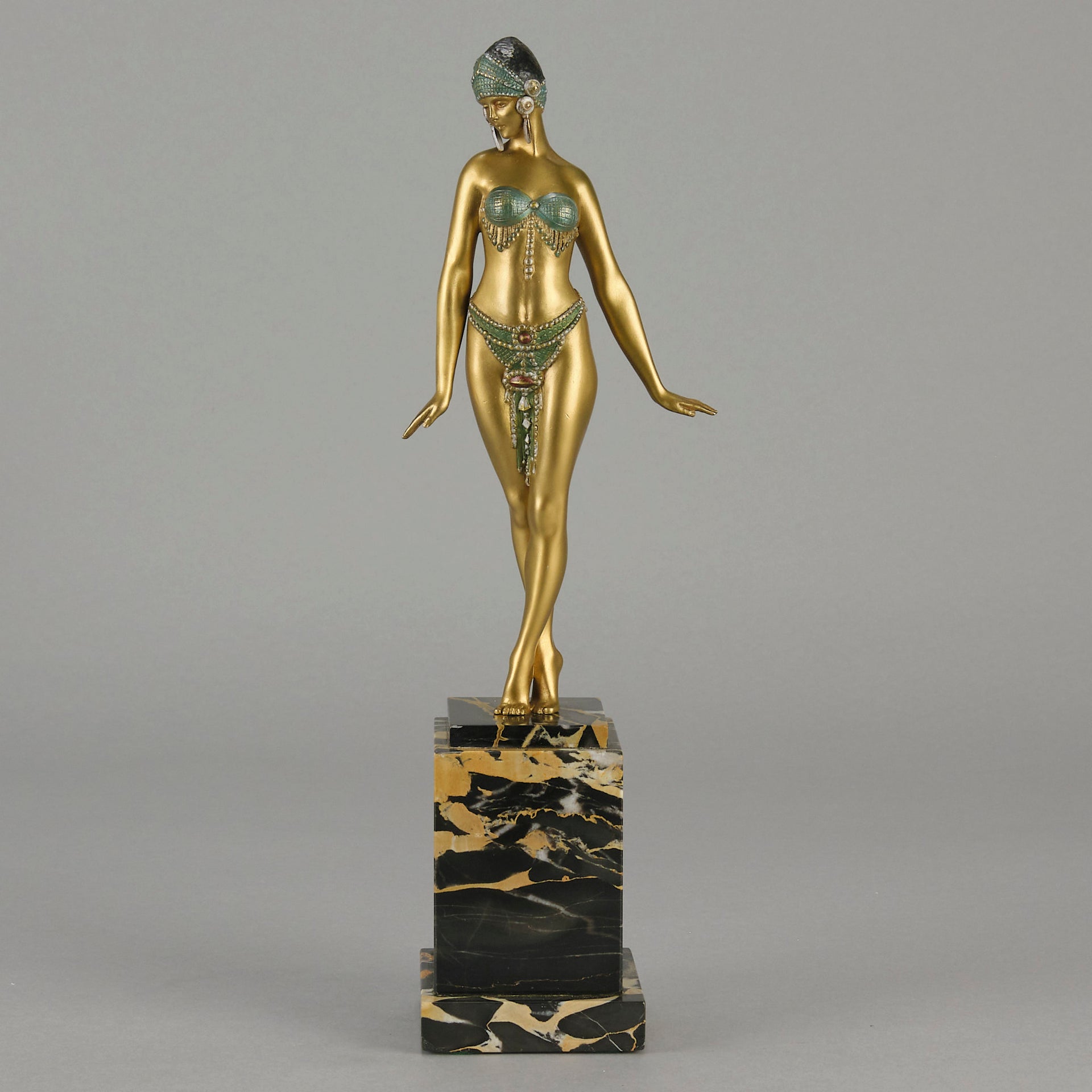 Alexandrian Dancer by Demetre Chiparus A fabulous Art Deco gilt bronze figure of a beautiful Egyptian dancer in full dance costume with her arms held by her sides, hand finished in stunning gilded and cold painted enamel colour, raised on a portoro marble base