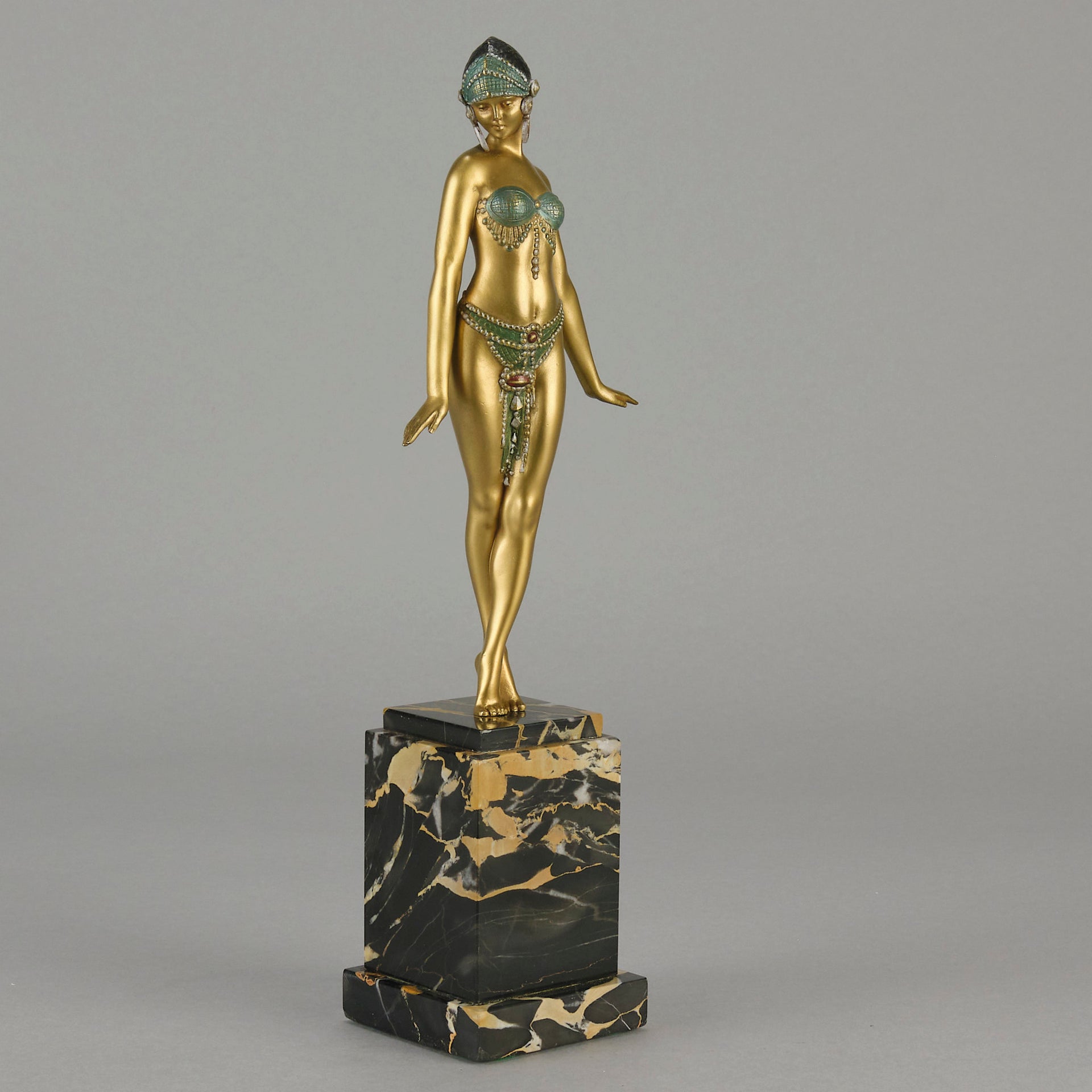 Alexandrian Dancer by Demetre Chiparus A fabulous Art Deco gilt bronze figure of a beautiful Egyptian dancer in full dance costume with her arms held by her sides, hand finished in stunning gilded and cold painted enamel colour, raised on a portoro marble base