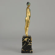 Alexandrian Dancer by Demetre Chiparus A fabulous Art Deco gilt bronze figure of a beautiful Egyptian dancer in full dance costume with her arms held by her sides, hand finished in stunning gilded and cold painted enamel colour, raised on a portoro marble base