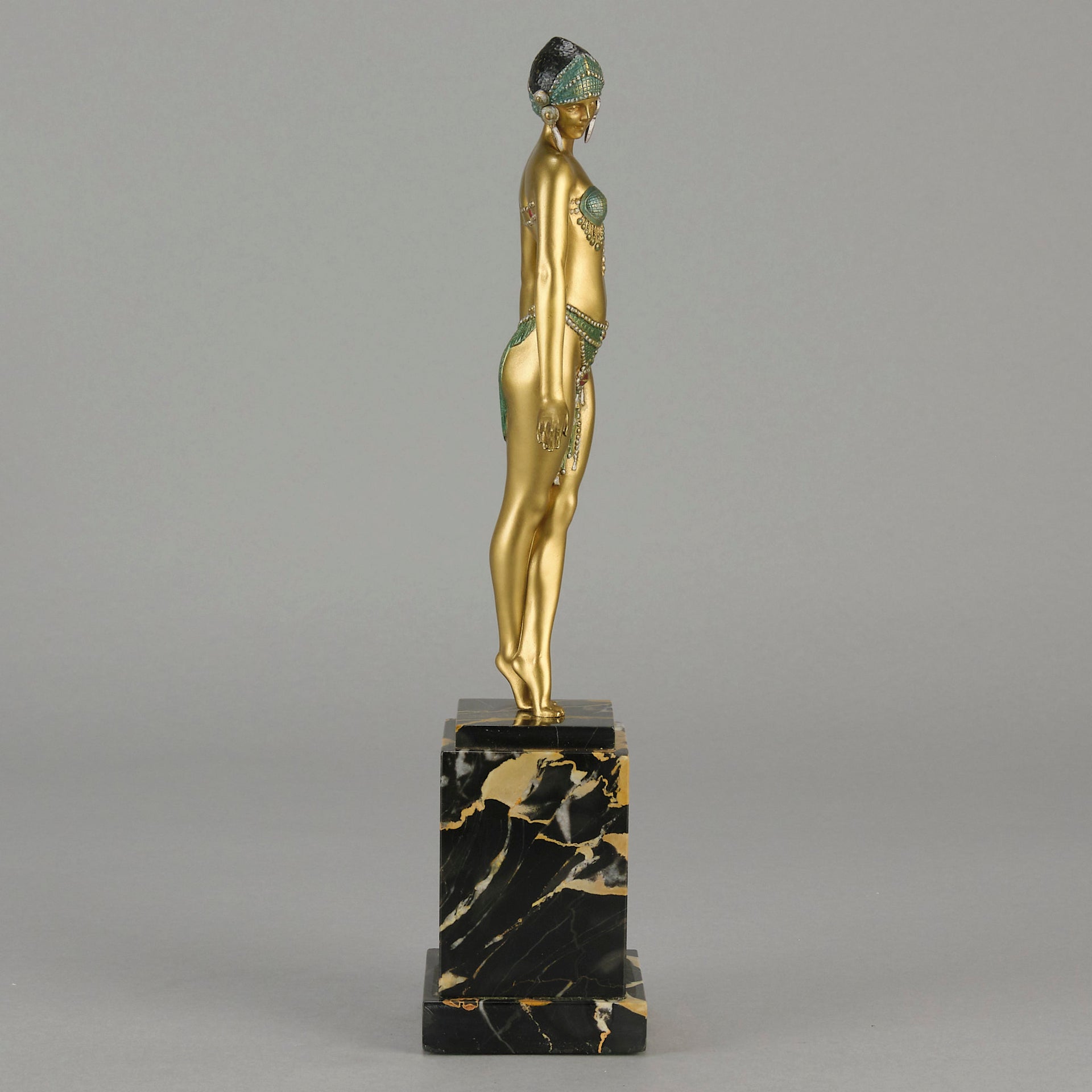 Alexandrian Dancer by Demetre Chiparus A fabulous Art Deco gilt bronze figure of a beautiful Egyptian dancer in full dance costume with her arms held by her sides, hand finished in stunning gilded and cold painted enamel colour, raised on a portoro marble base