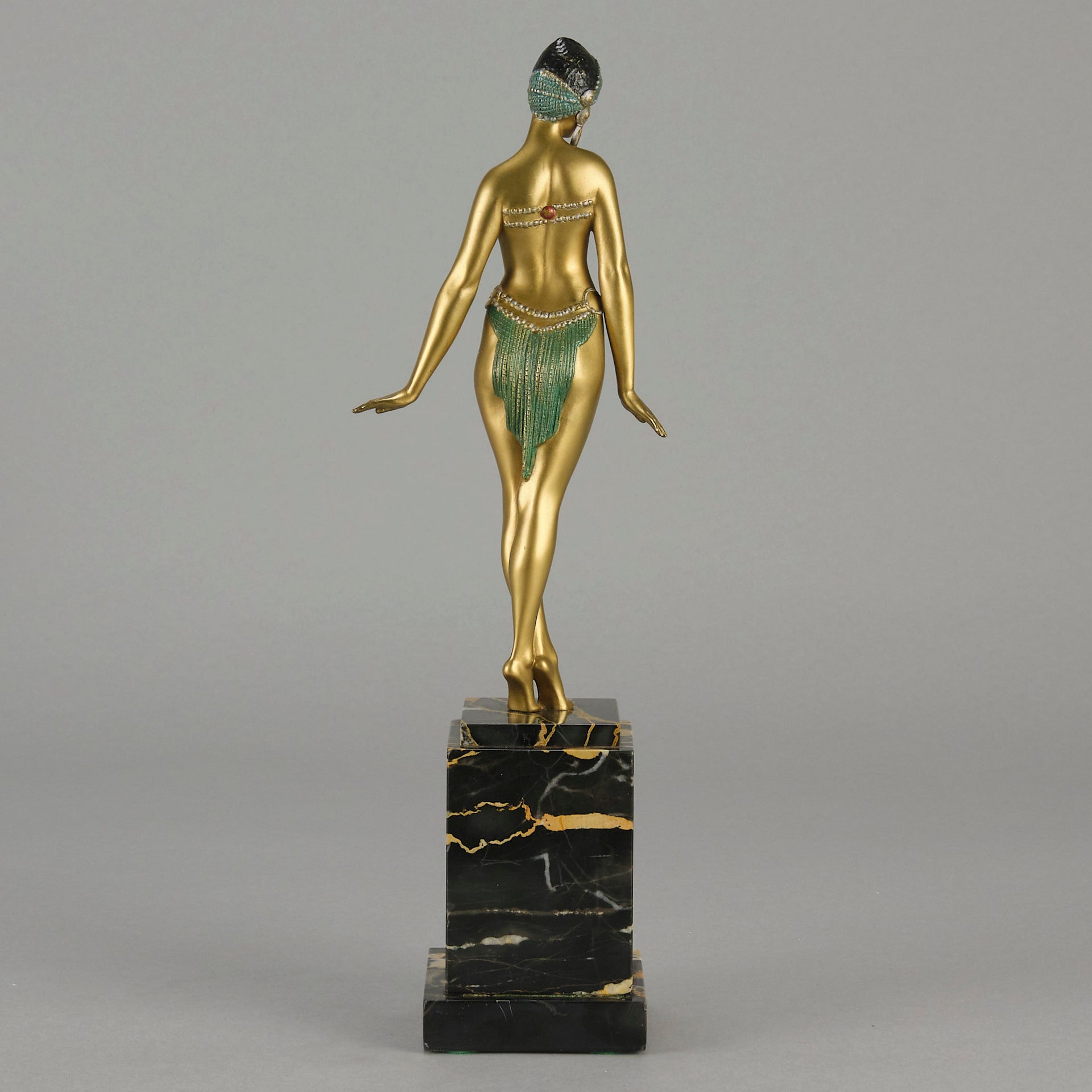 Alexandrian Dancer by Demetre Chiparus A fabulous Art Deco gilt bronze figure of a beautiful Egyptian dancer in full dance costume with her arms held by her sides, hand finished in stunning gilded and cold painted enamel colour, raised on a portoro marble base