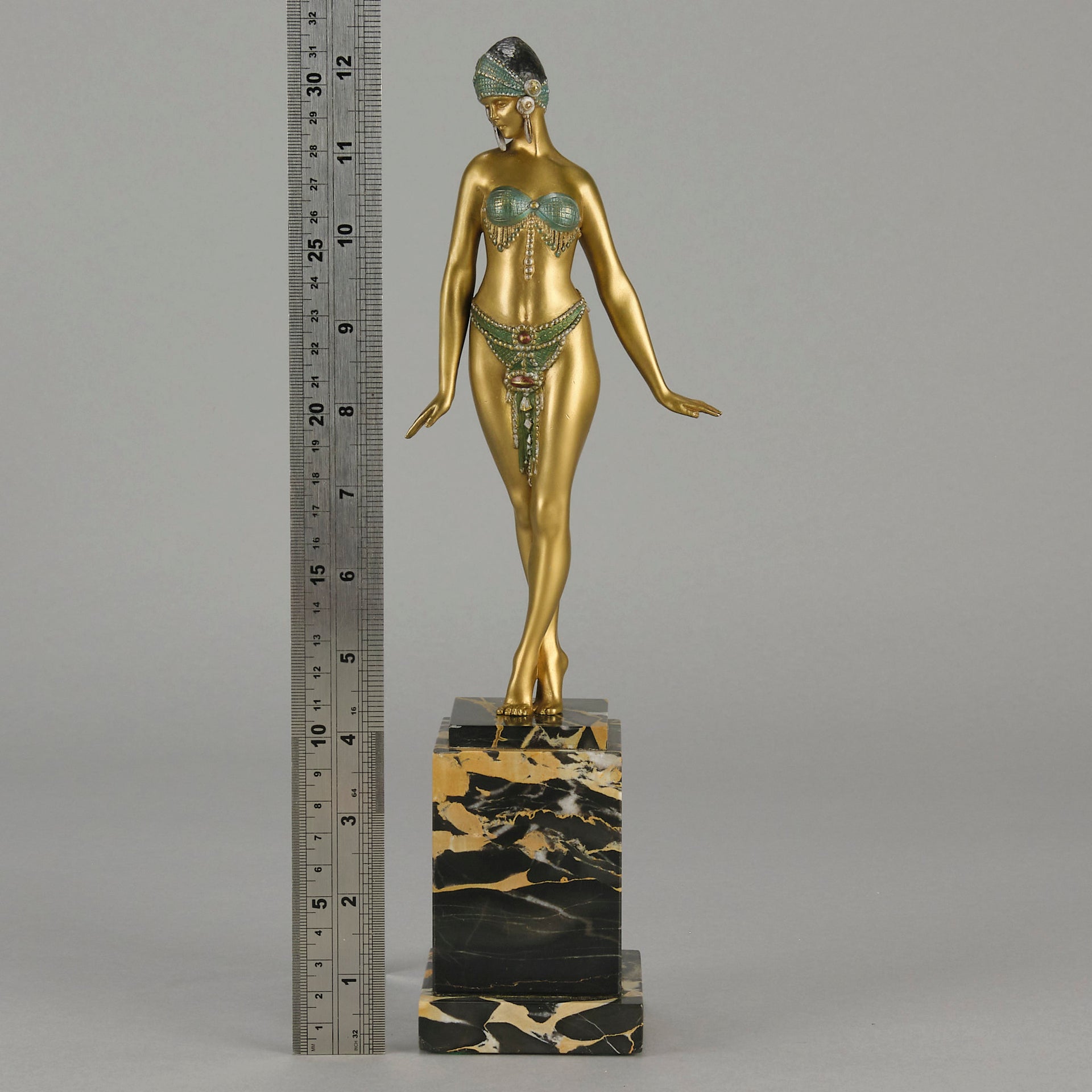 Alexandrian Dancer by Demetre Chiparus A fabulous Art Deco gilt bronze figure of a beautiful Egyptian dancer in full dance costume with her arms held by her sides, hand finished in stunning gilded and cold painted enamel colour, raised on a portoro marble base