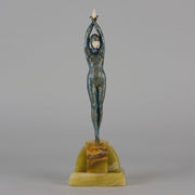  Starfish by Demetre Chiparus a  Art Deco cold painted silver and enamel bronze sculpture with ivory face and hands representing a young female Ballets Russes dancer wearing a metallic blue skin tight leotard further decorated in a bejewelled starfish pattern, modelled reaching upwards with both arms, her hands interlaced. Raised on a shaped onyx base