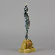  Starfish by Demetre Chiparus a  Art Deco cold painted silver and enamel bronze sculpture with ivory face and hands representing a young female Ballets Russes dancer wearing a metallic blue skin tight leotard further decorated in a bejewelled starfish pattern, modelled reaching upwards with both arms, her hands interlaced. Raised on a shaped onyx base