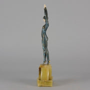  Starfish by Demetre Chiparus a  Art Deco cold painted silver and enamel bronze sculpture with ivory face and hands representing a young female Ballets Russes dancer wearing a metallic blue skin tight leotard further decorated in a bejewelled starfish pattern, modelled reaching upwards with both arms, her hands interlaced. Raised on a shaped onyx base