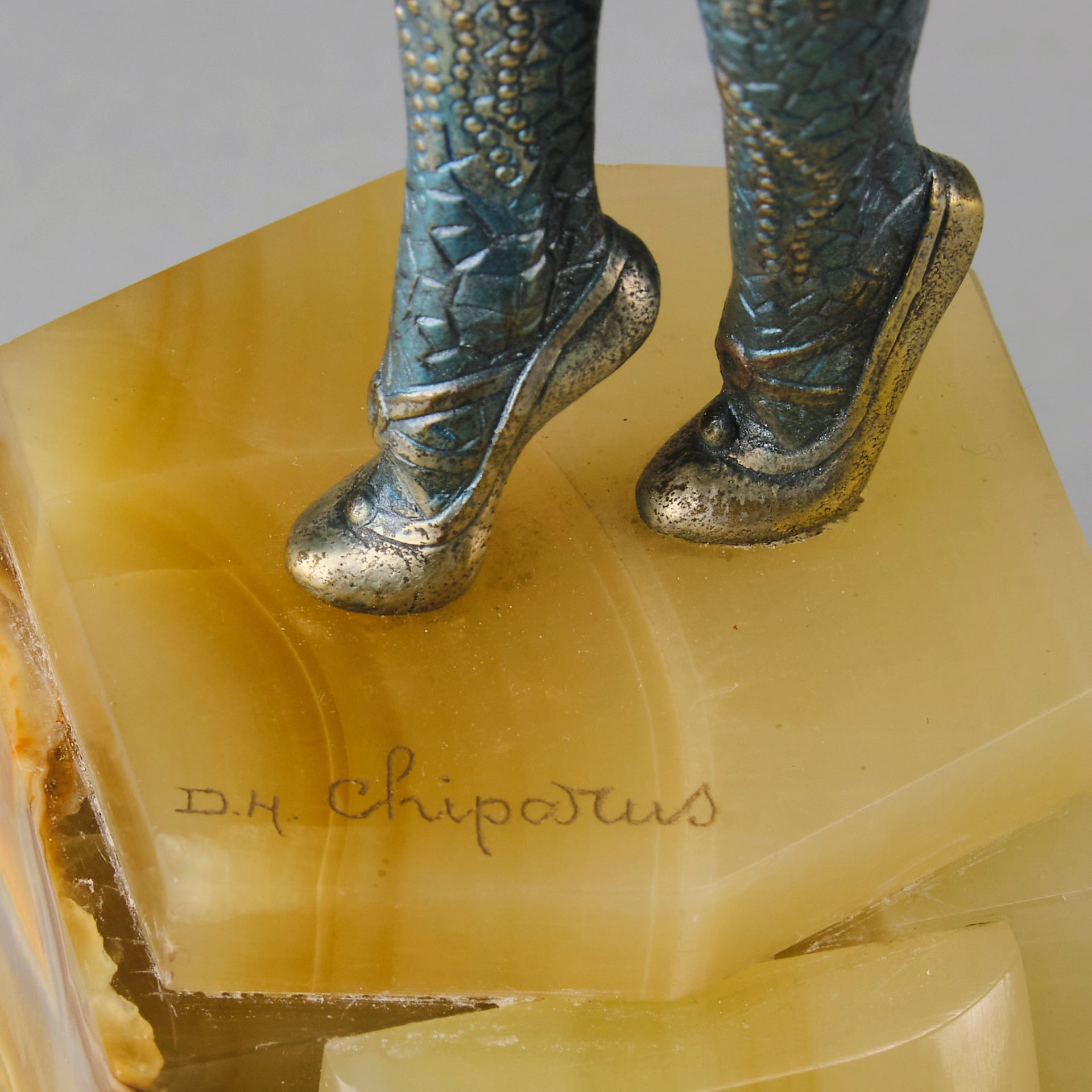  Starfish by Demetre Chiparus a  Art Deco cold painted silver and enamel bronze sculpture with ivory face and hands representing a young female Ballets Russes dancer wearing a metallic blue skin tight leotard further decorated in a bejewelled starfish pattern, modelled reaching upwards with both arms, her hands interlaced. Raised on a shaped onyx base