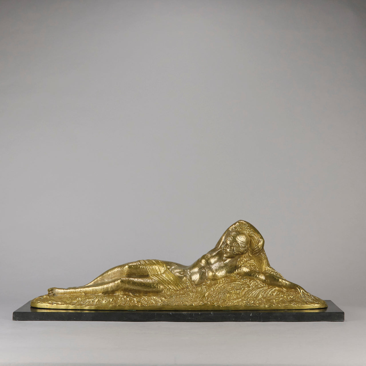 Été by Demetre Chiparus a fabulous Art Deco cold painted gilt and silver bronze figure of a beautiful young woman reclining on a bed of wheat sheaves