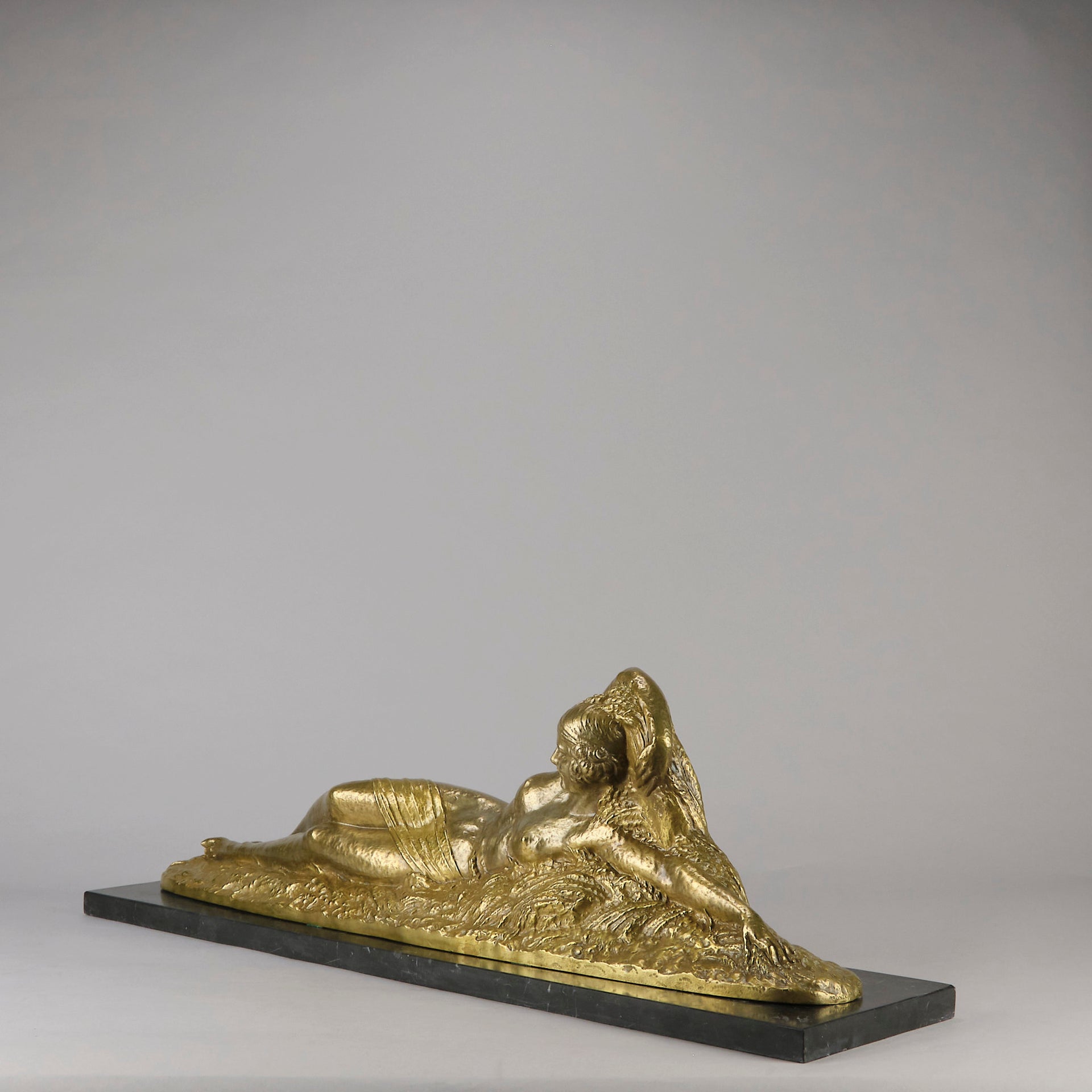 Été by Demetre Chiparus a fabulous Art Deco cold painted gilt and silver bronze figure of a beautiful young woman reclining on a bed of wheat sheaves
