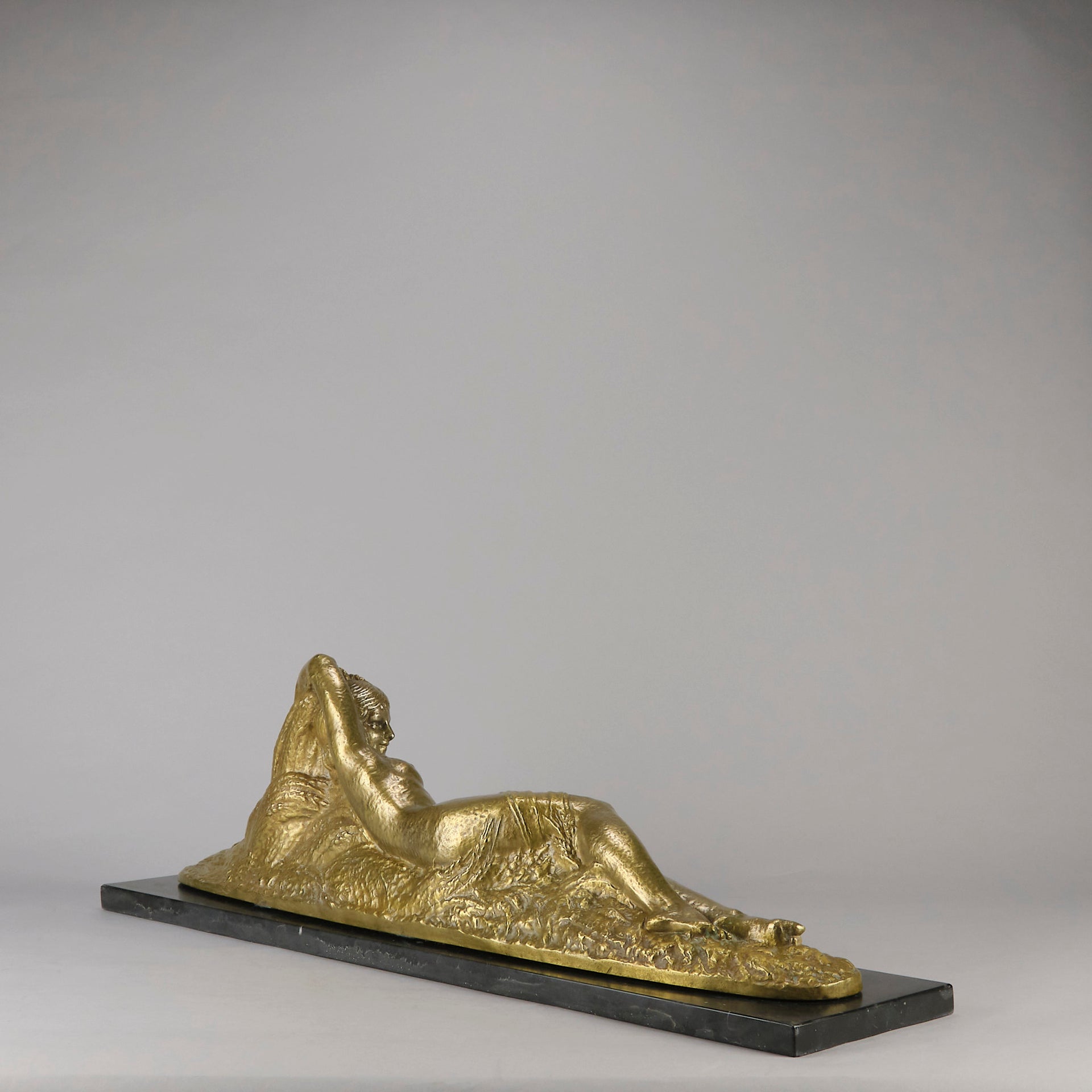 Été by Demetre Chiparus a fabulous Art Deco cold painted gilt and silver bronze figure of a beautiful young woman reclining on a bed of wheat sheaves
