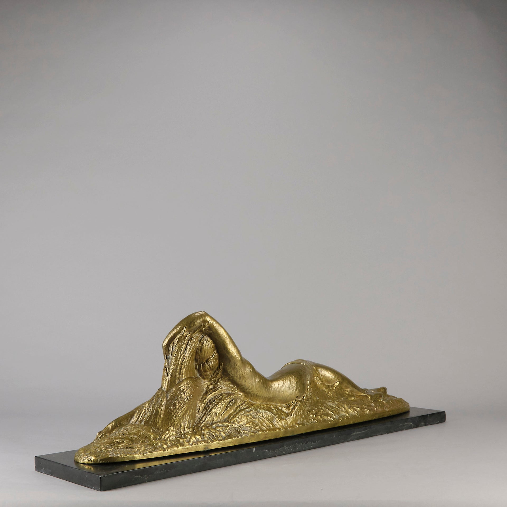 Été by Demetre Chiparus a fabulous Art Deco cold painted gilt and silver bronze figure of a beautiful young woman reclining on a bed of wheat sheaves
