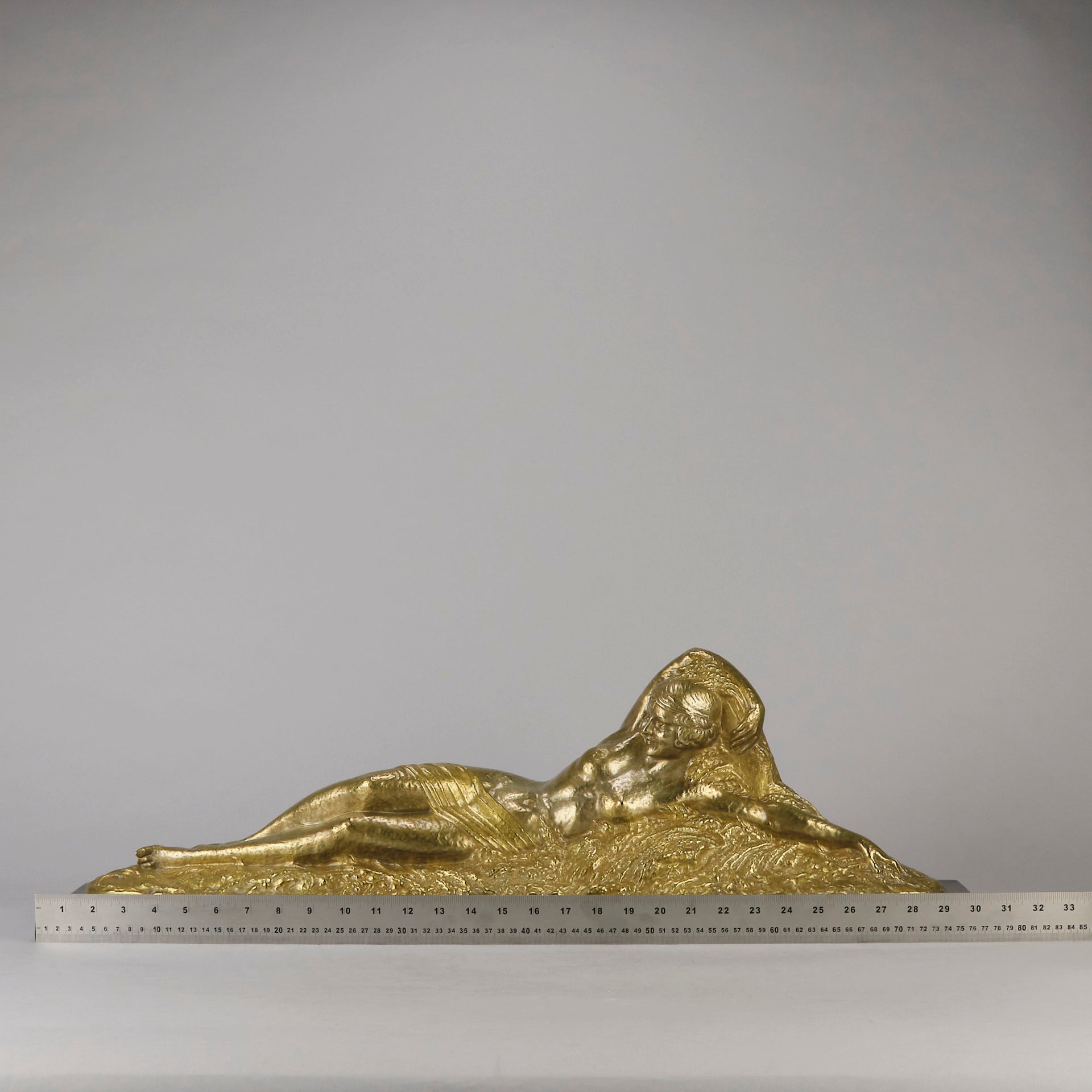 Été by Demetre Chiparus a fabulous Art Deco cold painted gilt and silver bronze figure of a beautiful young woman reclining on a bed of wheat sheaves