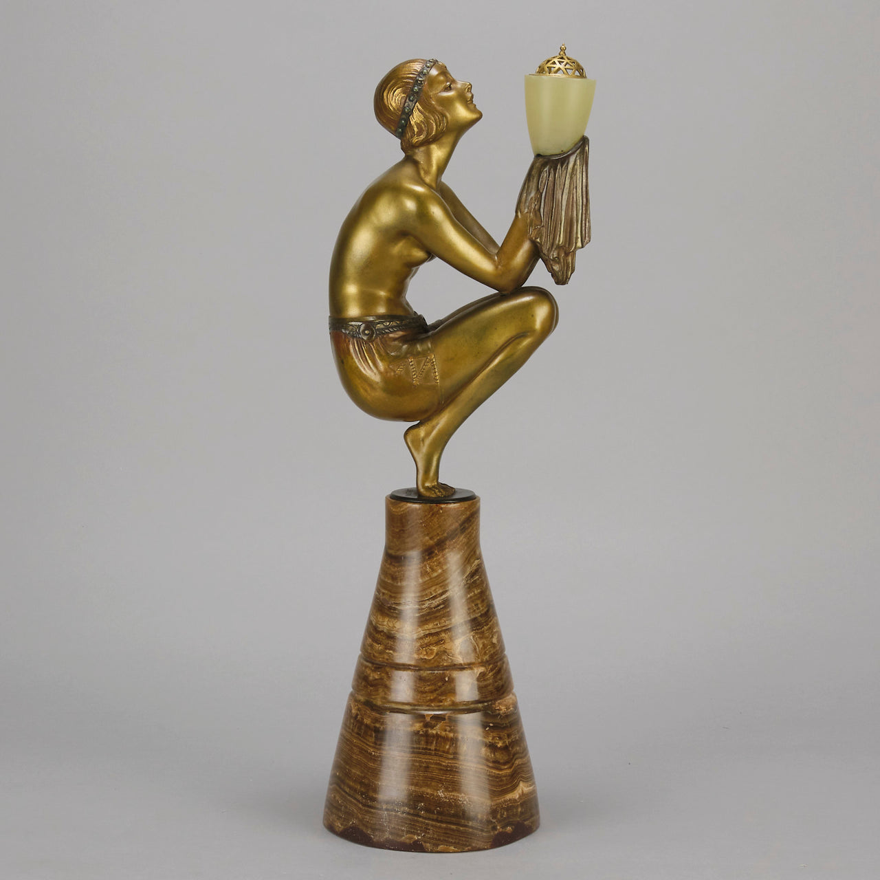 Oblivion by Georges Ducernet - Art Deco Statue 1930s a cold painted bronze figure of a dancer in a crouched pose holding a lidded urn. Exhibiting excellent colour and detail, raised on a conical marble plinth 