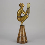 Oblivion by Georges Ducernet - Art Deco Statue 1930s a cold painted bronze figure of a dancer in a crouched pose holding a lidded urn. Exhibiting excellent colour and detail, raised on a conical marble plinth 