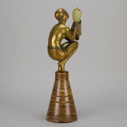 Oblivion by Georges Ducernet - Art Deco Statue 1930s a cold painted bronze figure of a dancer in a crouched pose holding a lidded urn. Exhibiting excellent colour and detail, raised on a conical marble plinth 
