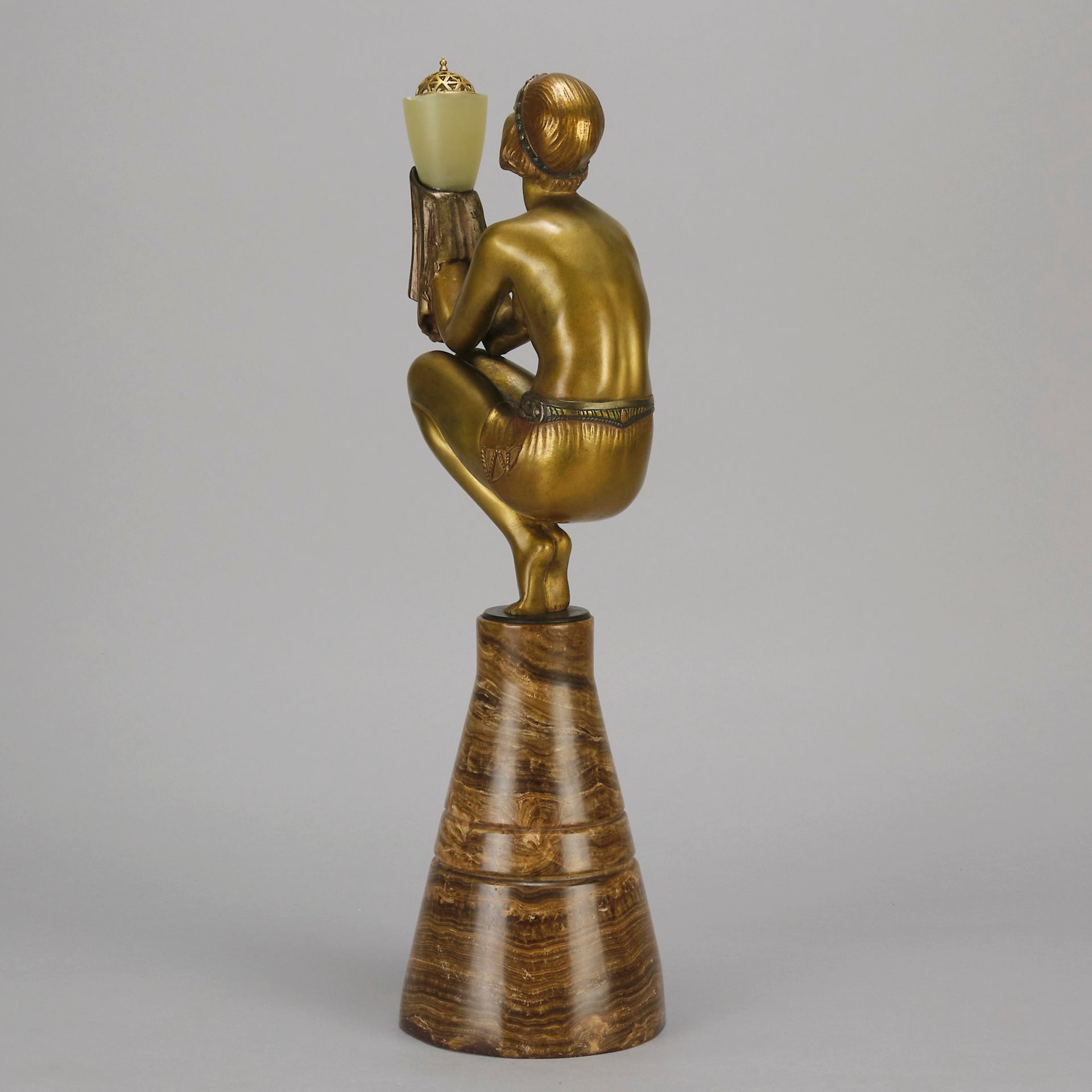 Oblivion by Georges Ducernet - Art Deco Statue 1930s a cold painted bronze figure of a dancer in a crouched pose holding a lidded urn. Exhibiting excellent colour and detail, raised on a conical marble plinth 