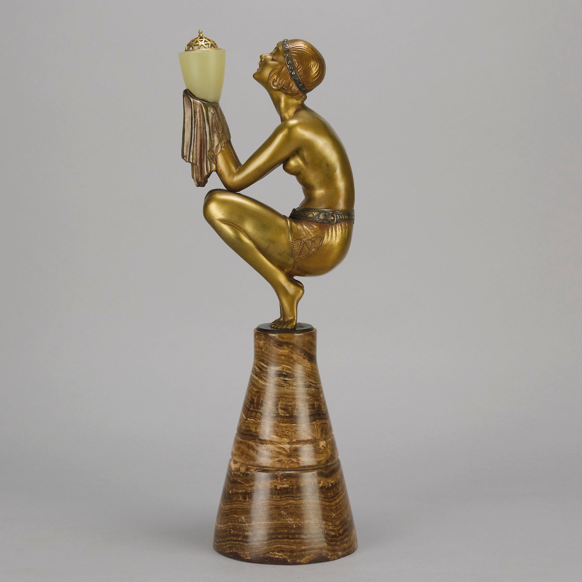 Oblivion by Georges Ducernet - Art Deco Statue 1930s a cold painted bronze figure of a dancer in a crouched pose holding a lidded urn. Exhibiting excellent colour and detail, raised on a conical marble plinth 