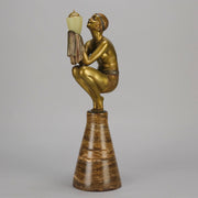 Oblivion by Georges Ducernet - Art Deco Statue 1930s a cold painted bronze figure of a dancer in a crouched pose holding a lidded urn. Exhibiting excellent colour and detail, raised on a conical marble plinth 