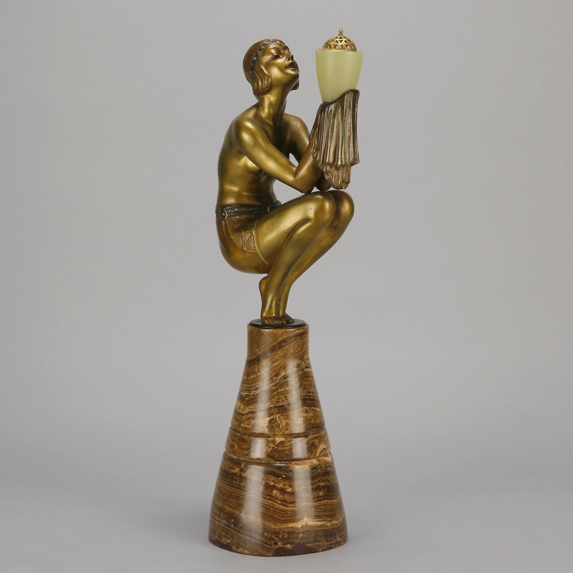 Oblivion by Georges Ducernet - Art Deco Statue 1930s a cold painted bronze figure of a dancer in a crouched pose holding a lidded urn. Exhibiting excellent colour and detail, raised on a conical marble plinth 
