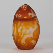Easter  Egg Vase with Bunny by Émile Gallé. A beautiful and very rare early 20th Century cameo glass lidded egg shaped vase acid cut and etched with an Easter bunny sitting on a nest of eggs under the boughs of some trees in deep orange on a cream/ivory field