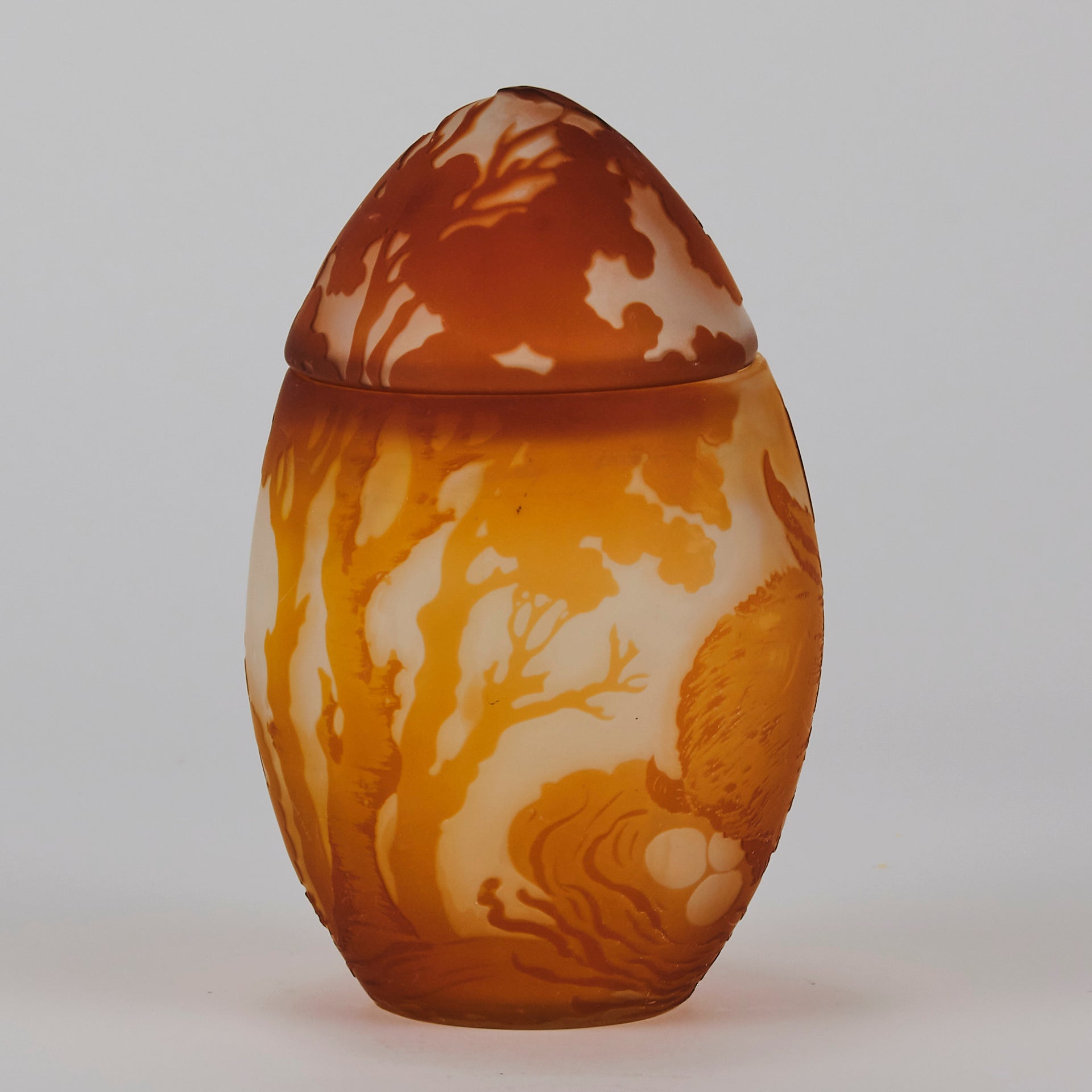 Easter  Egg Vase with Bunny by Émile Gallé. A beautiful and very rare early 20th Century cameo glass lidded egg shaped vase acid cut and etched with an Easter bunny sitting on a nest of eggs under the boughs of some trees in deep orange on a cream/ivory field