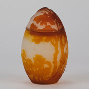 Easter  Egg Vase with Bunny by Émile Gallé. A beautiful and very rare early 20th Century cameo glass lidded egg shaped vase acid cut and etched with an Easter bunny sitting on a nest of eggs under the boughs of some trees in deep orange on a cream/ivory field