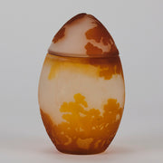 Easter  Egg Vase with Bunny by Émile Gallé. A beautiful and very rare early 20th Century cameo glass lidded egg shaped vase acid cut and etched with an Easter bunny sitting on a nest of eggs under the boughs of some trees in deep orange on a cream/ivory field