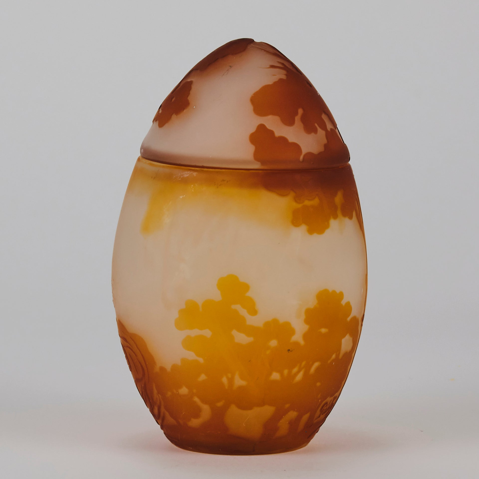 Easter  Egg Vase with Bunny by Émile Gallé. A beautiful and very rare early 20th Century cameo glass lidded egg shaped vase acid cut and etched with an Easter bunny sitting on a nest of eggs under the boughs of some trees in deep orange on a cream/ivory field