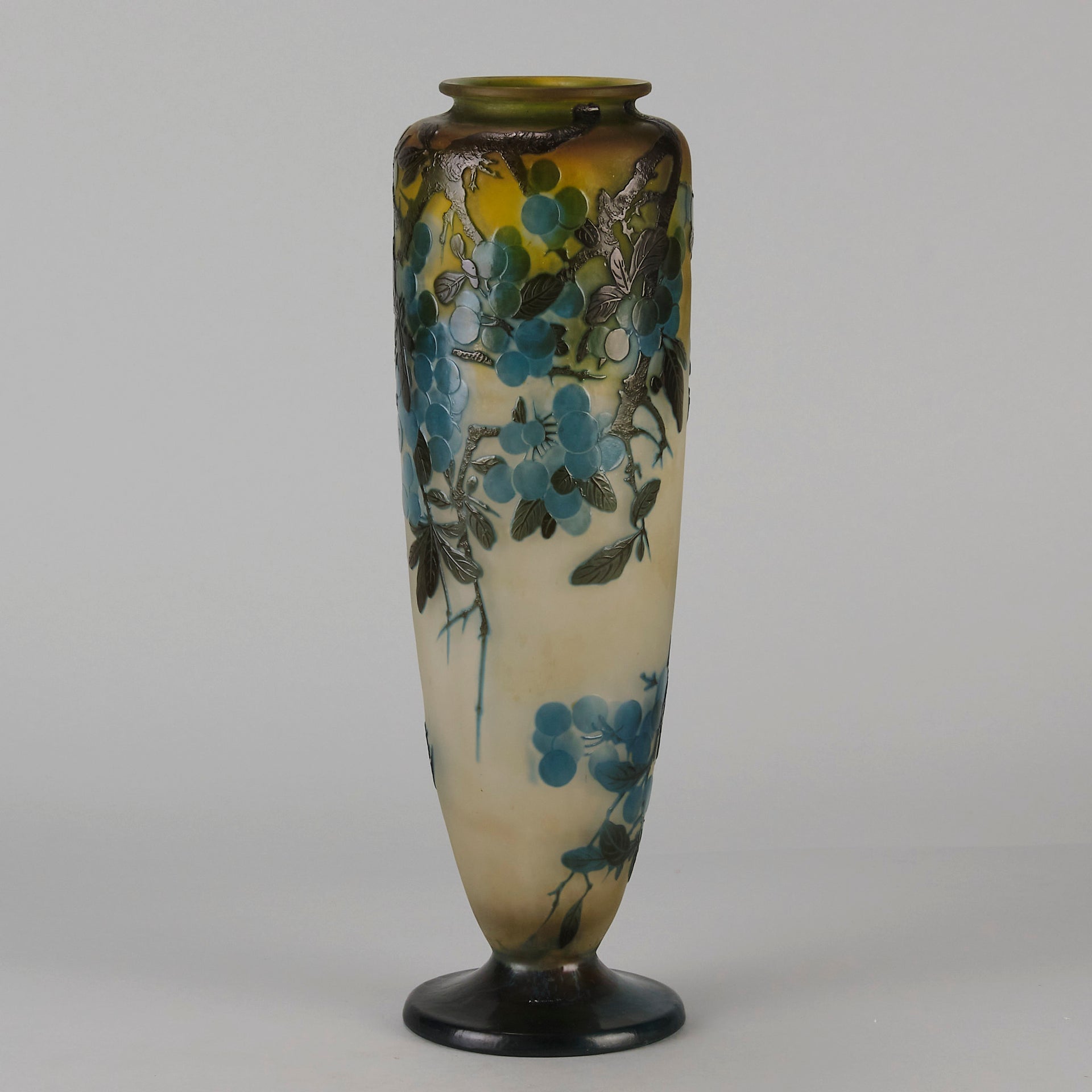 Art Nouveau Glass Vase Fruiting Sloe Berries by Emile Gallé An early 20th Century cameo glass vase acid cut and etched with a fruiting tree branch blooming with electric blue sloe berries against a pale cream/yellow background
