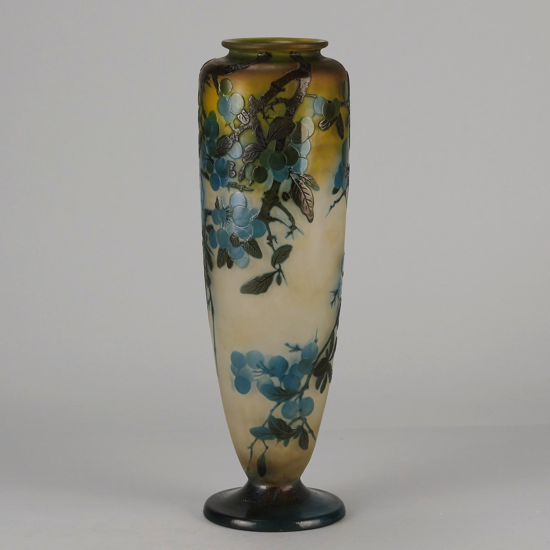 Art Nouveau Glass Vase Fruiting Sloe Berries by Emile Gallé An early 20th Century cameo glass vase acid cut and etched with a fruiting tree branch blooming with electric blue sloe berries against a pale cream/yellow background
