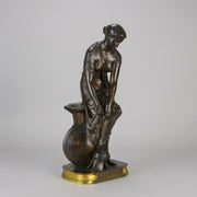 Thetis by Emile Hébert - a French late 19th Century bronze, of a striking female warrior figure known as Thetis the Greek Goddess of War. She is adjusting her shin guards in preparation for her next opponent, whilst sitting on an anvil. Raised on top of a partly gilded base