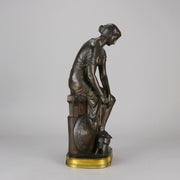 Thetis by Emile Hébert - a French late 19th Century bronze, of a striking female warrior figure known as Thetis the Greek Goddess of War. She is adjusting her shin guards in preparation for her next opponent, whilst sitting on an anvil. Raised on top of a partly gilded base